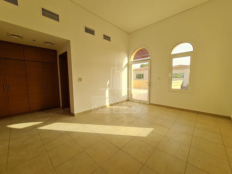 Huge-bedroom-with-built-in-wardrobe-attached-toilet-and-entry-to-the-terrace-and-small-window-in-a-house-in-Abu-Dhabi-for-sale