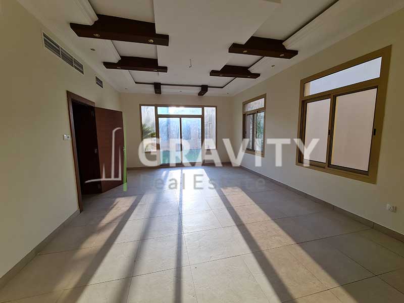 Room-with-a-ceiling-modified-with-wooden-fixtures-having-windows