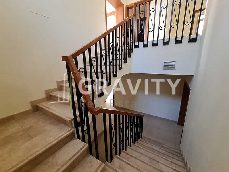 Staircase-from-ground-floor-to-first-floor-having-marble-steps-wooden-railing-in-a-5-bedroom-villa-for-sale