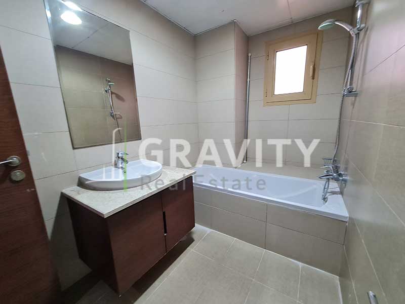 Attached-toilet-in-the-master-bedroom-in-the-Golf-gardens-Villa-has-bathtub-sink-mirror-and-shower-head