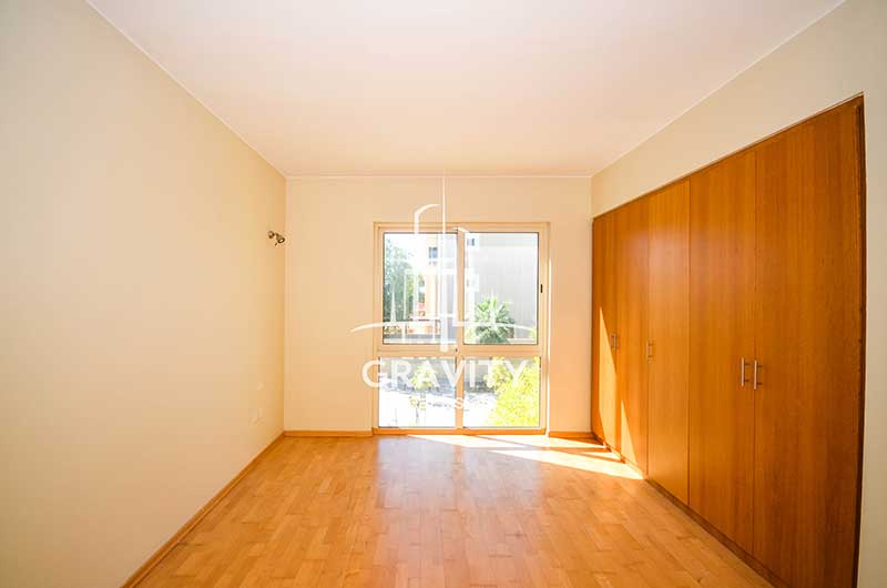 Bedroom-in-a-4-bedroom-Townhouse-for-sale-in-Al-Raha-garden-that-wooden-floorings-fitted-wooden-wardrobes-and-a-window