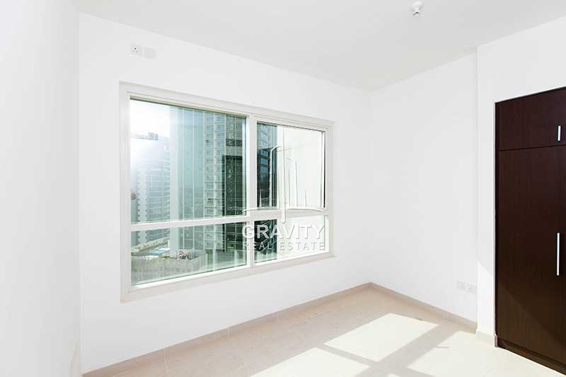 Bedroom-with-small-window-and-built-in-wardrobes-in-burooj-views