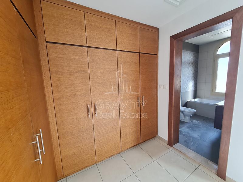 Huge-Built-wooden-wardrobe-in-the-master-bedroom-of-a-villa-in-Al-Raha-Golf-gardens-with-an-entry-to-the-attached-toilet