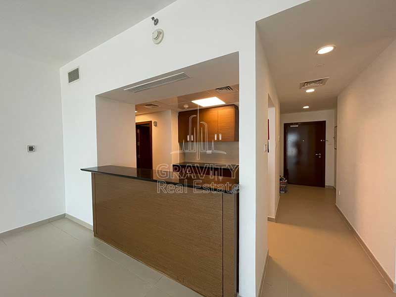 Open-kitchen-with-a-marbeled-tabletop-partition-with-lobby-entrance-to-the-side-in-gate-tow