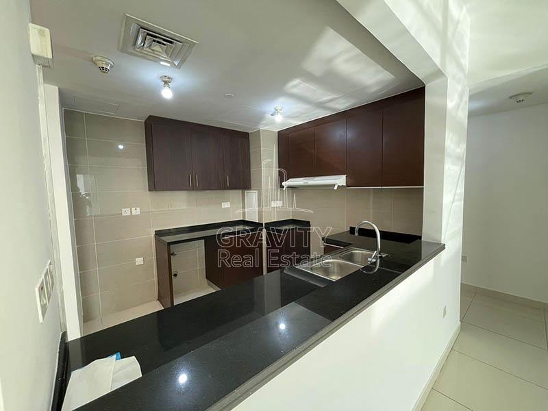 Open-kitchen-with-wooden-cabients-in-apartment-for-sale-Marina-Blue-Towers