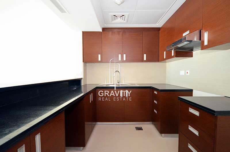 Open-kitchen-with-wooden-cabinets-in-1-bedroom-apprtment-fro-sale-in-abu-dhabi