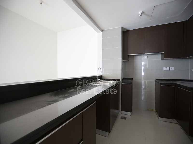 Open-kitchen-with-wooden-cabinets-in-marina-heights-tower