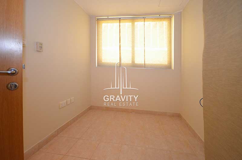 Room-in-4-bedroom-villa-for-sale-in-Al-Raha-garden-having-white-walls-and-tiled-floors