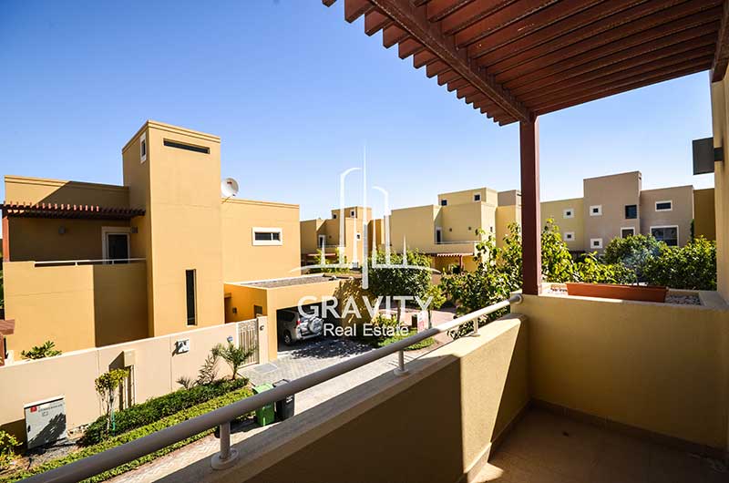 Serene-View-from-a-shaded-balcony-having-cream-colored-townhouses-all-around-in-Al-Raha-gardens