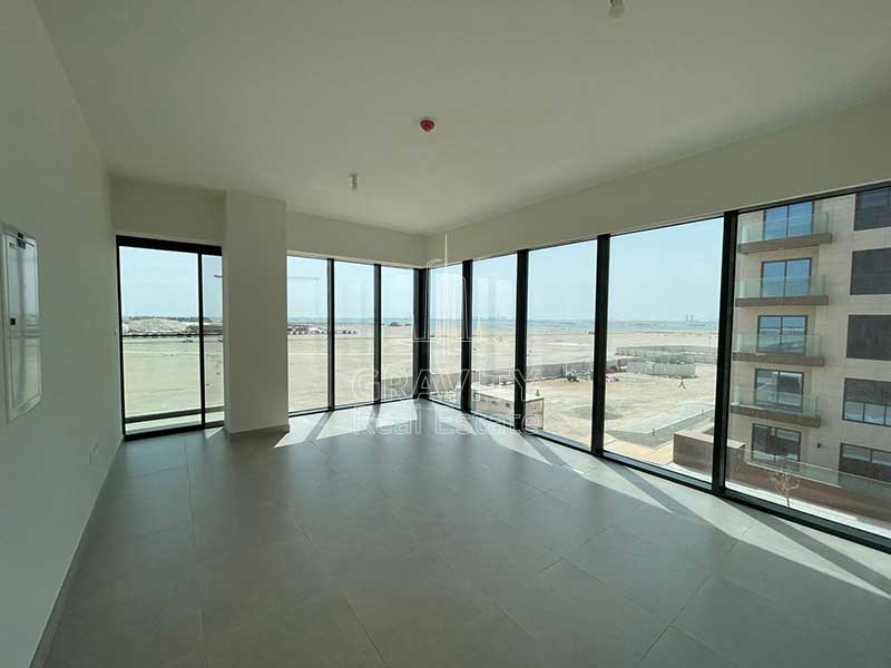 Soho-Square-Saadiyat-property-living-room-with-glazzed-windows-and-coumminty-view.