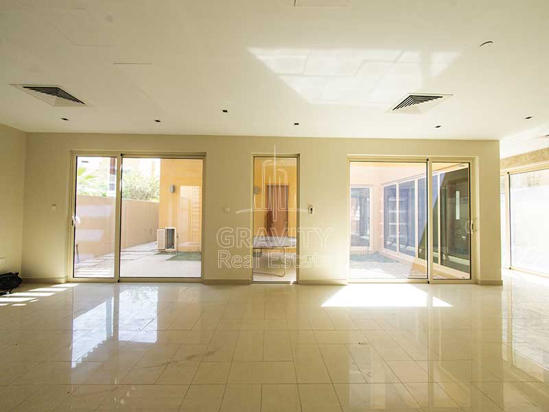 Spacious-living-area-with-tiles-and-windowed-doors-in-5-Bedroom-house-for-sale-in-Al-Raha-Garden