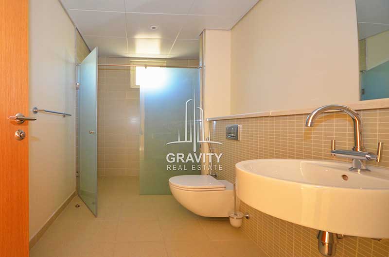 Spacious-toilet-with-a-cubicle-for-shower-a-wash-basin-a-mirror-and-a-toilet-in-Al-Raha-gardens-villa