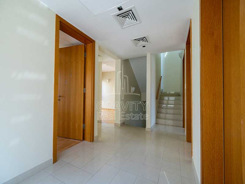 Staircase-lobby-opening-up-to-4-rooms-and-a-floor-above-in-Al-Raha-Gardens-Villa