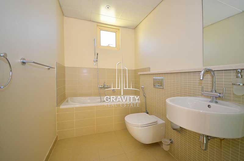 Toilet-with-cream-colored-rectangular-tiles-on-the-walls-in-Al-Raha-Garden-4-bedroom-villas-for-sale