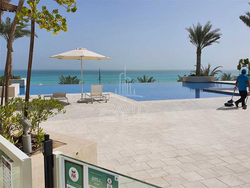 View-of-the-beach-and-infinity-pool-from-the-ground-floor-of-a-mamsha-saadiyat-one-bedroom-apartment-loft-