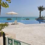 View-of-the-beach-and-infinity-pool-from-the-ground-floor-of-a-mamsha-saadiyat-one-bedroom-apartment-loft