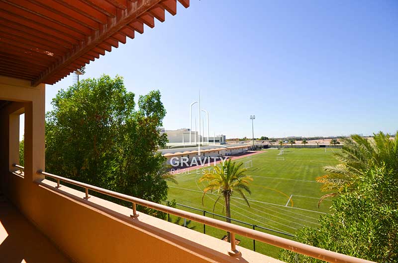 balcony-that-has-brown-colored-walls-and-railings-with-a-view-to-a-football-field-in-a-3-bedroom-townhouse