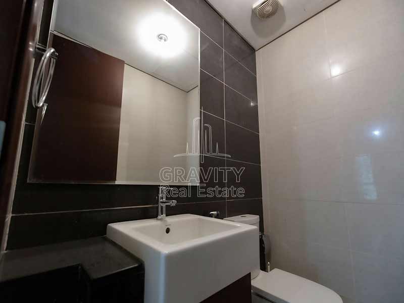 bathroom-with-mirror-and-marble-fittings-in-al-maha-tower-marina-square-abu-dhabi