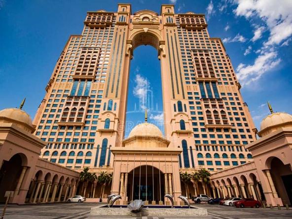 fairmont-marina-abu-dhab-huge-bulding-with-palm-on-the-side