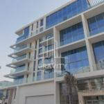 mamsha-saadiyat-island-bulding-from-outside-with-double-glazed-windows-and-trees-in-the-entrance