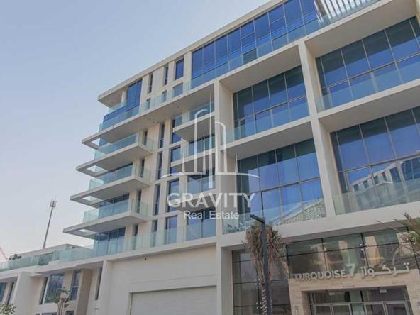 mamsha-saadiyat-island-bulding-from-outside-with-double-glazed-windows-and-trees-in-the-entrance