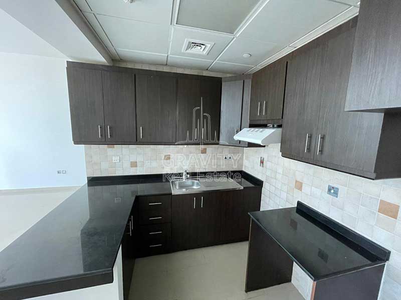 massive-kitchen-with-brown-cabinets-and-sink-in-hydra-avenue-c5