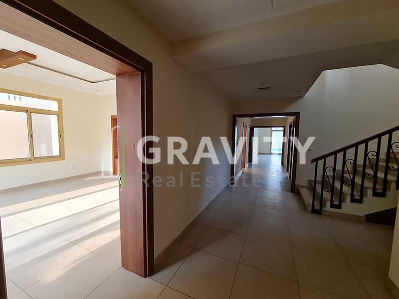 opening-between-two-rooms-that-leads-to-a-staircase-and-a-long-corridor-in-5-bedroom-Villa-in-the-Golf-gardens