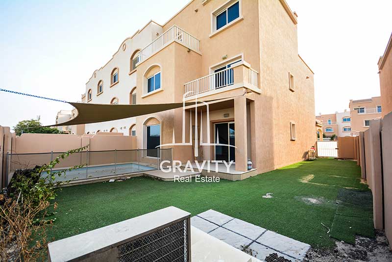 reef-villas-abudhabi-propety-garden-with-sun-shade-and-glass-door