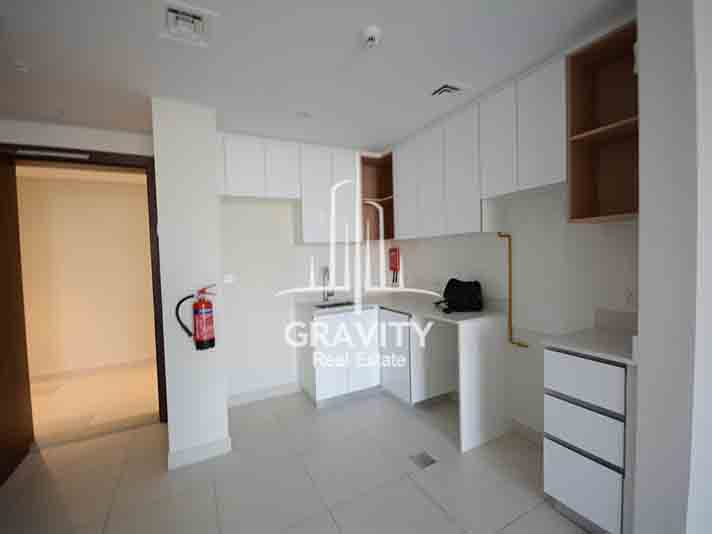 Open-kitchen-with-white-cabinets-in-Reflection-Towers