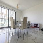 dining-area-with-tables-and-chairs-and-couch-in-al-raha-lofts-al-raha-beach