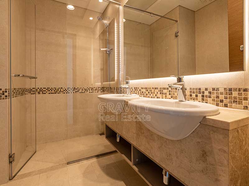 well-lit-bathroom-with-shower-area-in-yas-island-ansam-2-bedroom-apartment