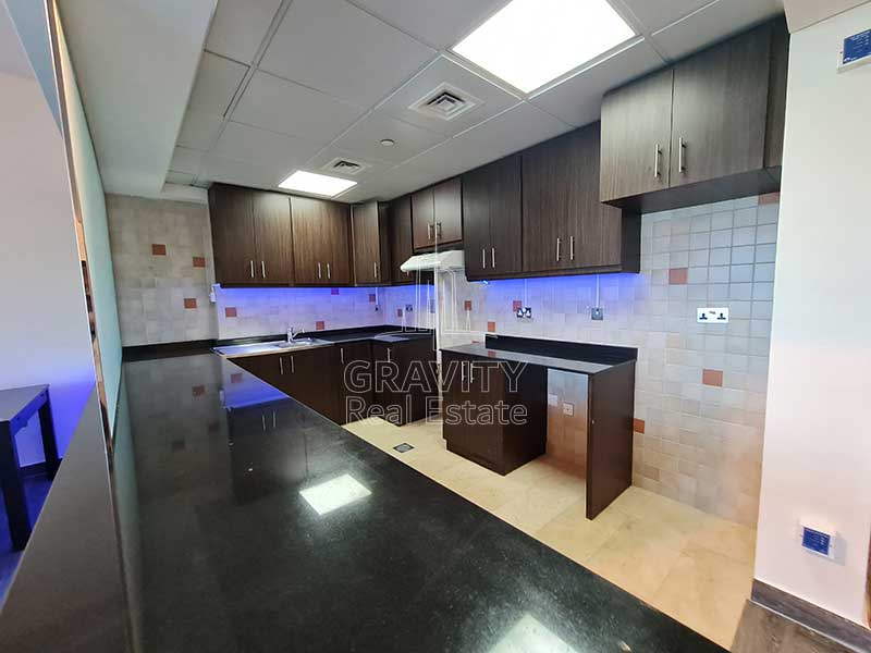 vast-kitchen-with-brown-cabinets-in-2-bedroom-townhouse-in-hydra-avenue-reem-island