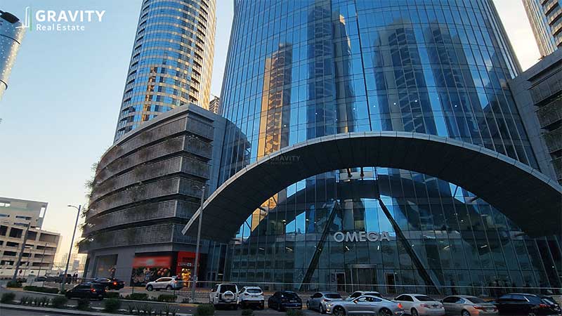 view-of-omega-towers-entrance-with-many-cars-parked-outside-and-the-spar-supermarket-to-the-side