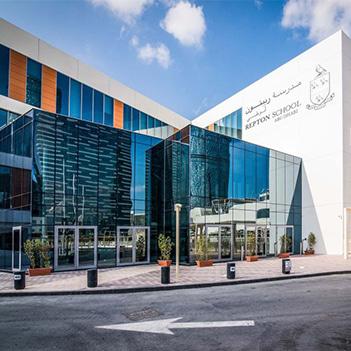 repton-school-reem-islands-entrance-as-viewed-from-the-street-with-the-repton-logo-showing-at-the-buildings-top-in-both-arabic-and-english