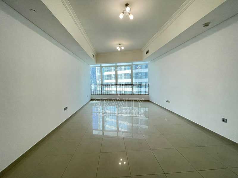 very-big-living-room-with-ceramic-tiles-and-nice-blue-tinted-windows-in-hydra-avenue-2-bedroom-apartment