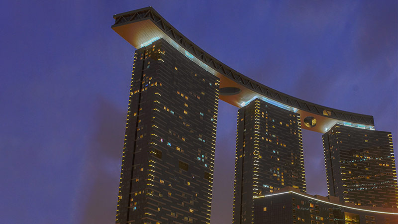 bottom-up-view-of-gate-towers-in-the-early-night-with-lights-everywhere