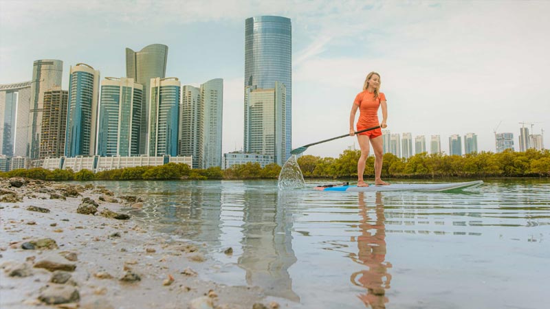 lady-paddling-on-top-of-surf-board-near-reem-island-mangrove-sea