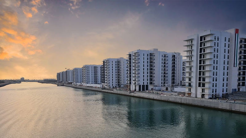 waters-edge-community-view-from-the-waters-with-eight-towers-showing-next-to-the-water-during-sunset