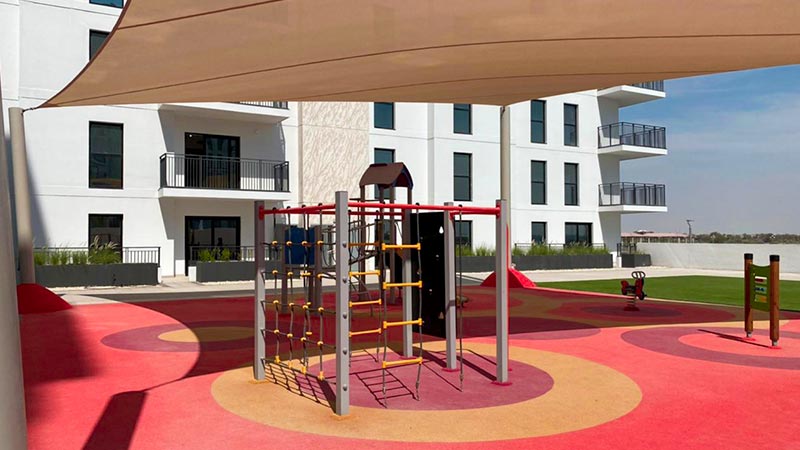 waters-edge-playground-with-jungle-gym-red-ground-and-shade