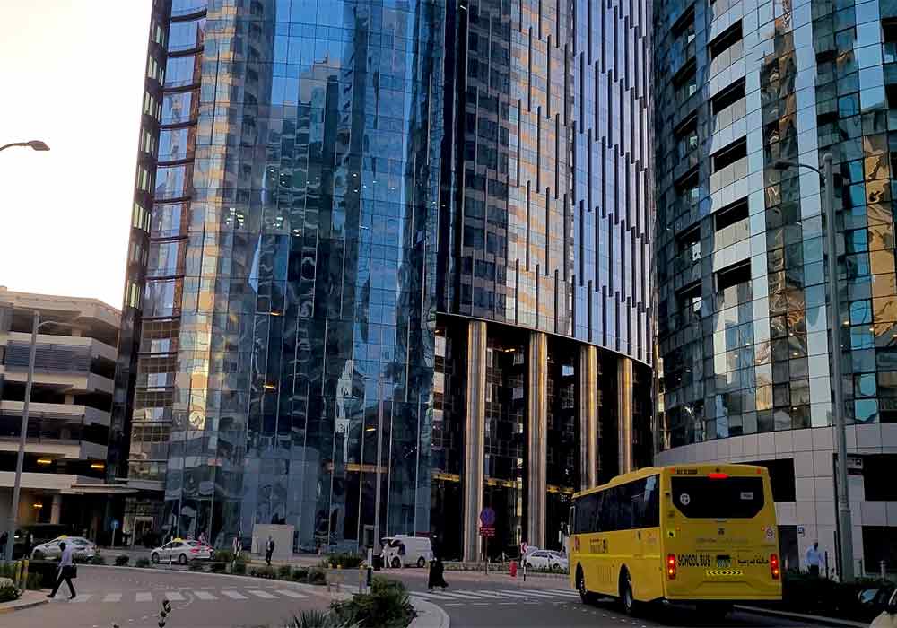 addax-office-tower-city-of-lights-view-of-entrance-bus-stop-and-zebra-crossing-during-the-evening