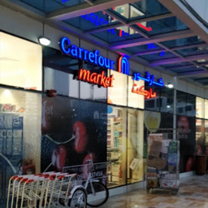 city-of-lights-carrefour-supermarkets-entrance-with-blue-and-red-neon-sign-lights-in-the-evening