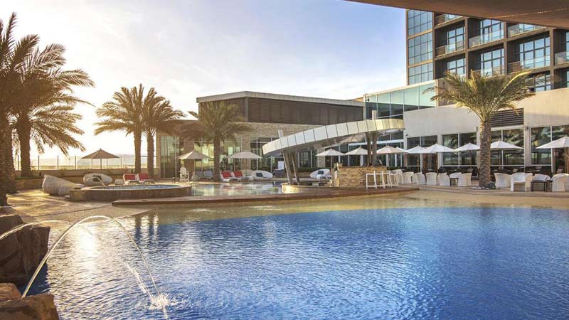 rotana-hotel-yas-island-above-podium-pool-and-lounging-area-during-the-early-evening