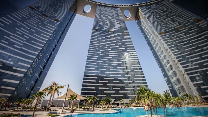 the-gate-towers-bottom-up-shot-from-podium-floor-pool-with-trees-everywhere