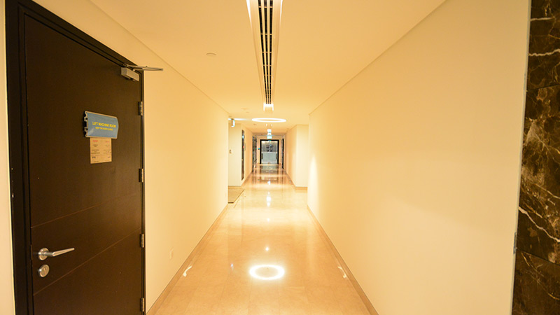 sky-tower-hallway-with-beige-walls-and-wooden-doors