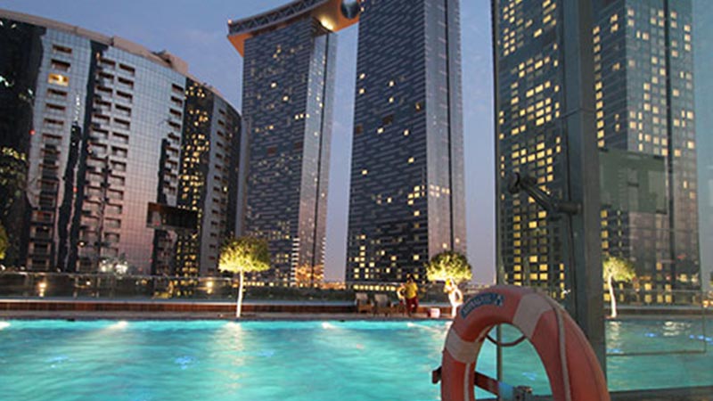 sun-tower-pool-at-night-with-arc-tower-and-gate-tower-in-the-background