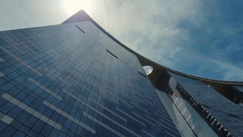 bottom-up-view-of-gate-tower-with-sun-behind-the-building