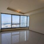 Cozy-Living-room-with-a-big-window-overlooking-the-sea-water-and-the-part-of-the-sky-tower-from-sun-towers