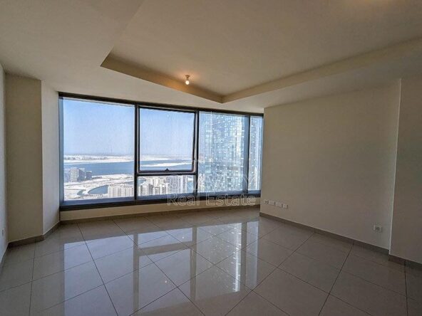 Cozy-Living-room-with-a-big-window-overlooking-the-sea-water-and-the-part-of-the-sky-tower-from-sun-towers