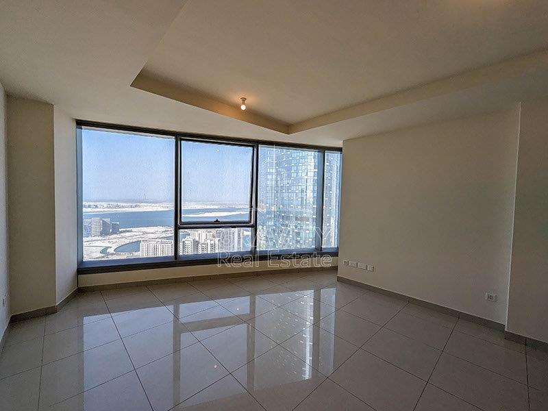 Cozy-Living-room-with-a-big-window-overlooking-the-sea-water-and-the-part-of-the-sky-tower-from-sun-towers