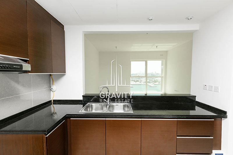 brown-kitchen-cabinets-in-a-2-bedroom-apartment-in-marina-blue-tower-reem-island